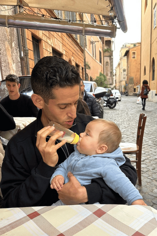 Dad feeding baby milk after using compact portable nursing pump perfect for travel.