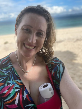 Mum wearing hands-free breast pump at the beach